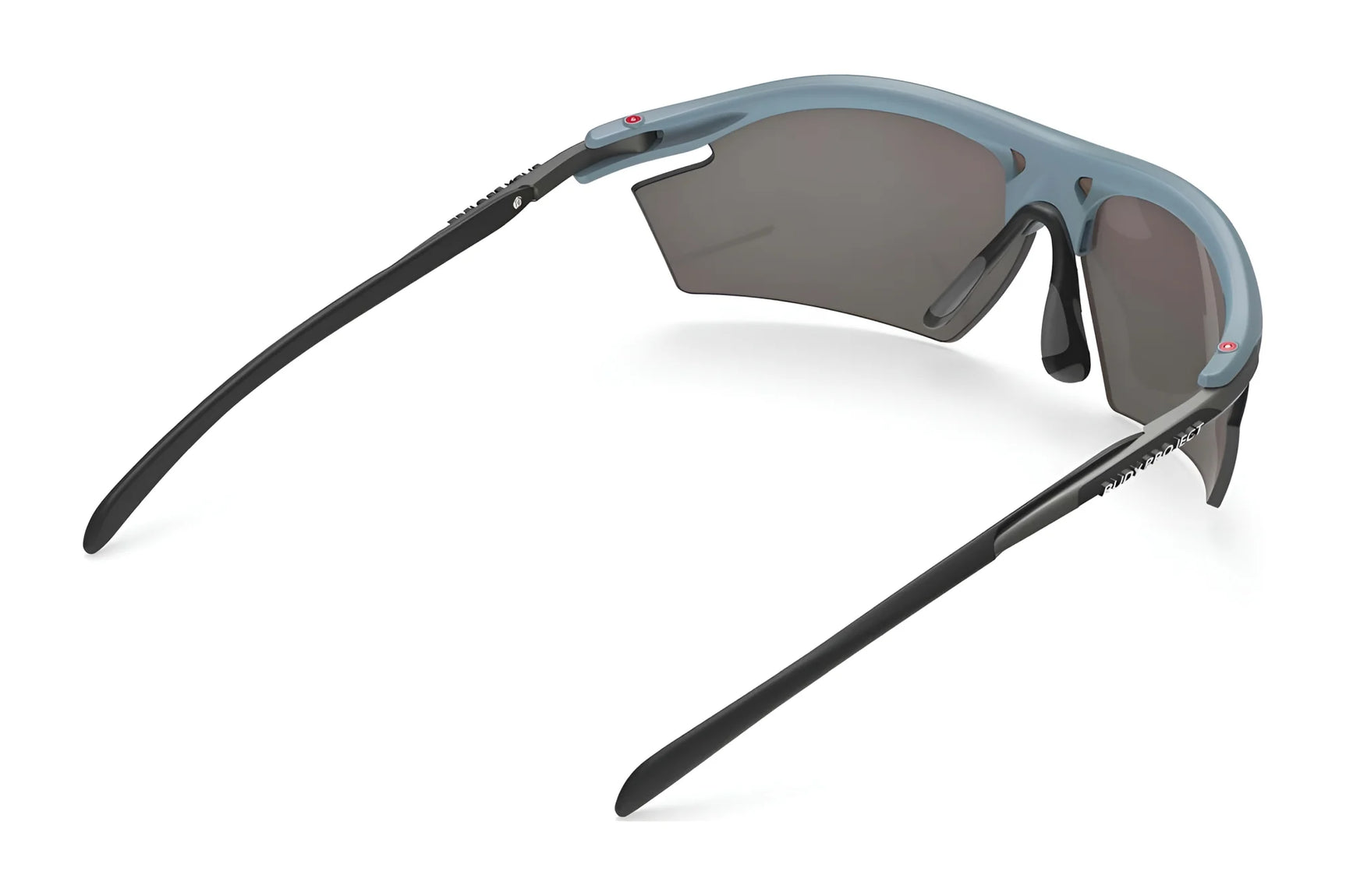 Rudy Project Rydon Sunglasses by Rudy Project shown from the rear, feature blue frames, dark lenses, and black arms on a white background. Adjustable anti-slip nosepads ensure comfort during intense activities. Rudy Project Rydon Sunglasses by Rudy Project shown from the rear, feature blue frames, dark lenses, and black arms on a white background. Adjustable anti-slip nosepads ensure comfort during intense activities.