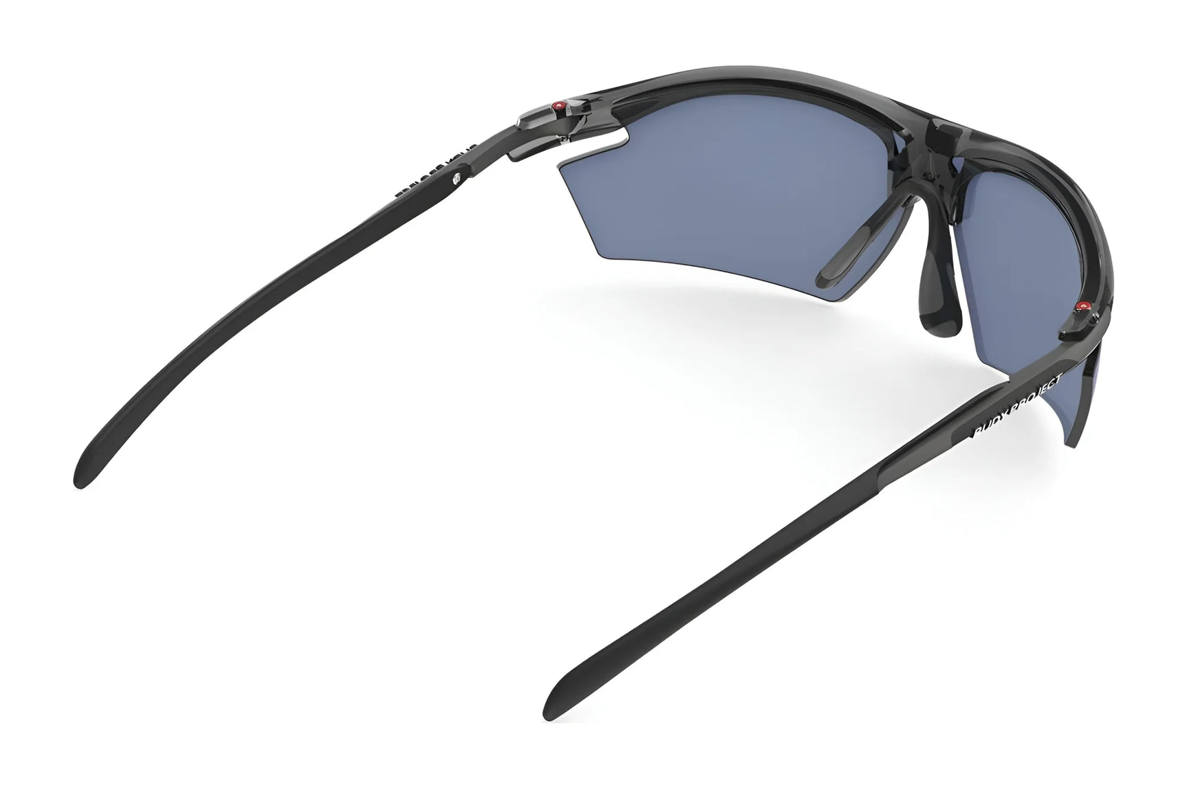Rudy Project Rydon Sunglasses by Rudy Project are black sports shades with semi-rimless blue lenses and adjustable anti-slip nosepads, shown from back and side angles on a white background. Rudy Project Rydon Sunglasses by Rudy Project are black sports shades with semi-rimless blue lenses and adjustable anti-slip nosepads, shown from back and side angles on a white background.