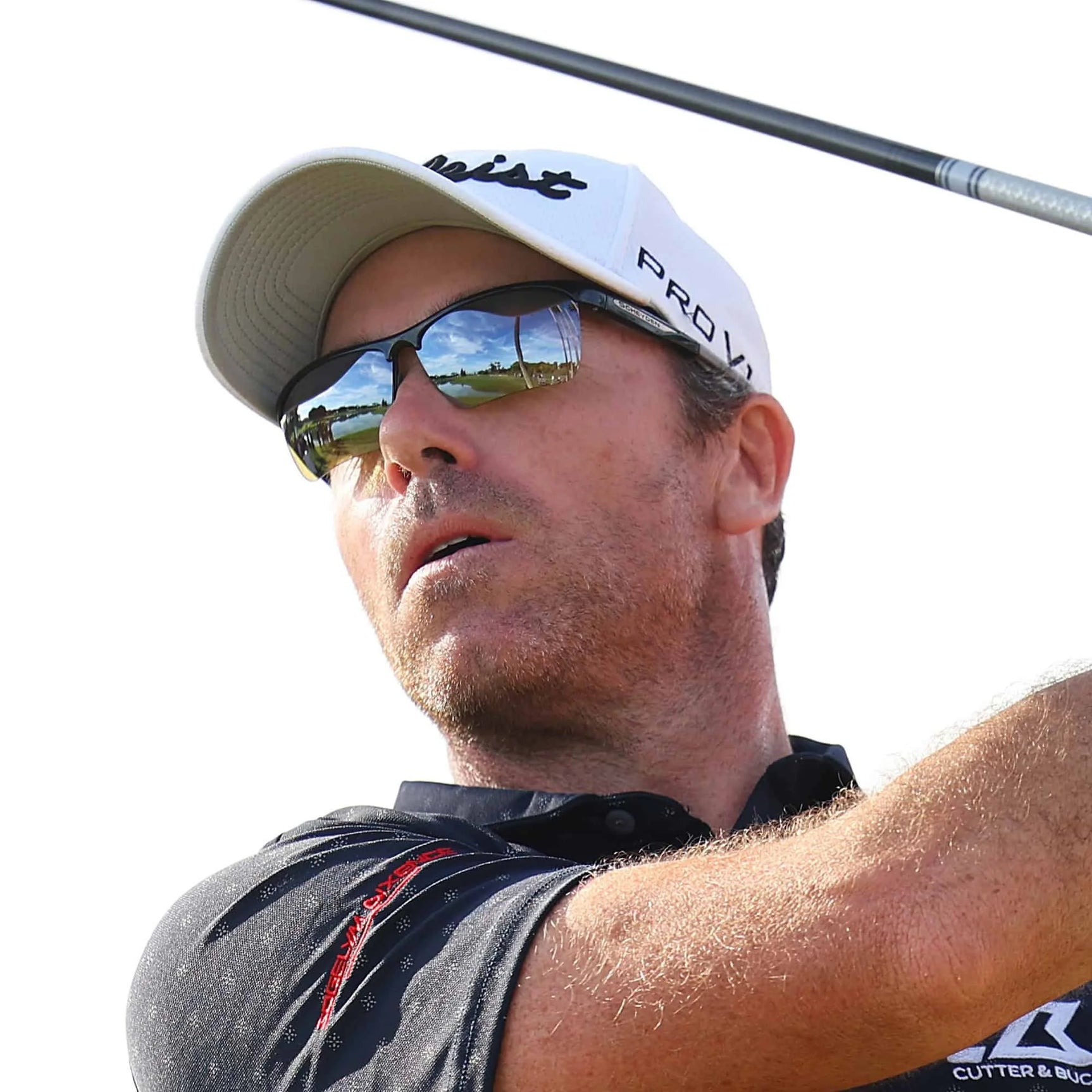 A person wearing Scheyden CIA GRABBER Sunglasses and a cap, swinging a golf club against a clear sky, perfectly embodies a relaxed day on the greens. A person wearing Scheyden CIA GRABBER Sunglasses and a cap, swinging a golf club against a clear sky, perfectly embodies a relaxed day on the greens.
